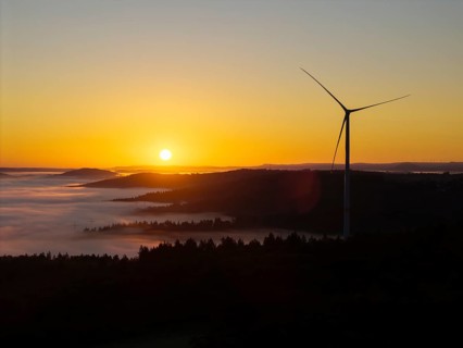 Impressive sunrise with wind turbine over foggy forest, near Schorndorf, Remstal, Rems-Murr-Kreis,