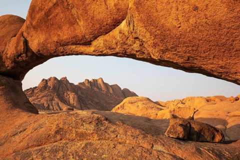 The Pondok mountains seen through The Bridge belong to the Spitzkoppe mountain compound.
