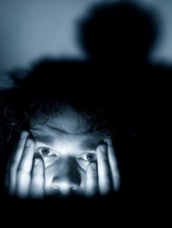 A close-up of a man whose face is marked by fear, symbolising anxiety disorders, panic attacks,