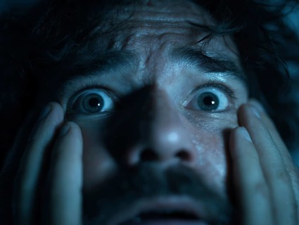 A close-up of a man whose face is marked by fear, symbolising anxiety disorders, panic attacks,