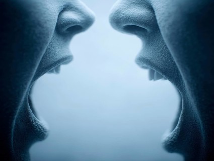 Two open mouths stand close to each other, shouting at each other and creating a tense atmosphere,