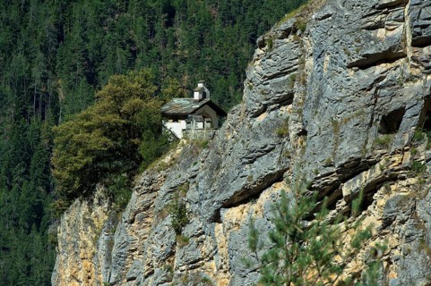 The small Chapelles des Pontis chapel on a rocky outcrop on the precipice, Chandolin, Val
