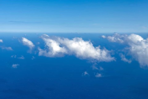 Aerial view from 11000 metres 36, 000 ft feet altitude on white cirrocumulus high cumulus clouds,