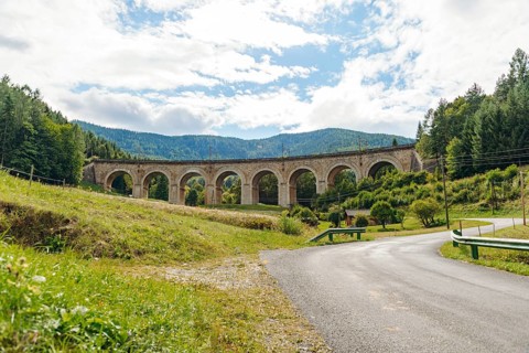 Adlitzgraben Viaduct, cloudy sky and green hills, Semmering Railway, Semmering, Lower Austria,