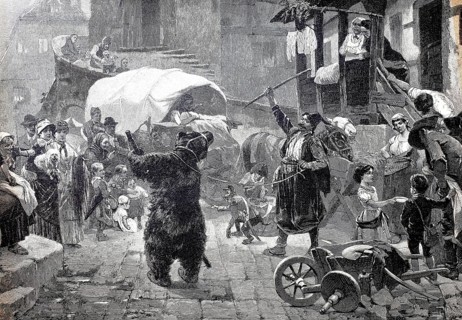 Bear handler with a dancing bear, trained bear, circus has come to town and is giving a