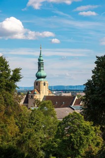 Church tower of St Stephan in Baden in front of a blue sky with clouds, Baden, Lower Austria,