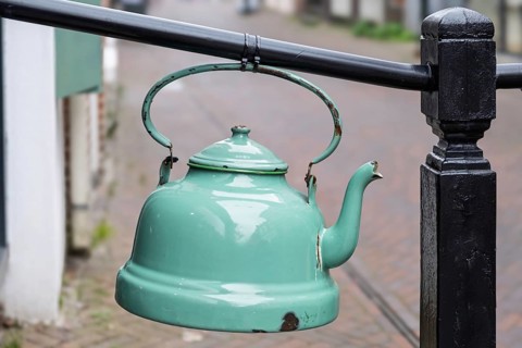 Old enamel tea or water kettle, decoration in front of a tea shop, province of Groningen,