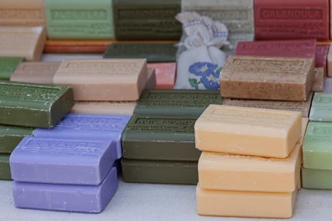 Market stall with various soaps, weekly market market Asciano, Tuscany, Italy