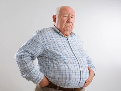 Elderly overweight man looks worried and holds his hands on his stomach, AI generated, AI generated