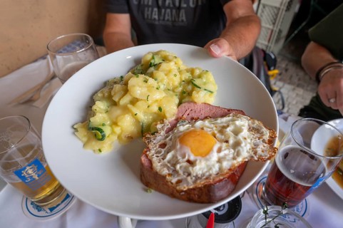 Leberkäse with fried egg and potato salad, served in a beer garden, Munich, Bavaria, Germany