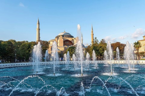Fountains splashing water in front of the hagia sophia in istanbul, turkey, during a sunny day