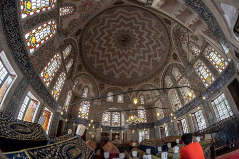 Wide angle view of the ornate ceiling and stained glass windows inside suleymaniye mosque, a