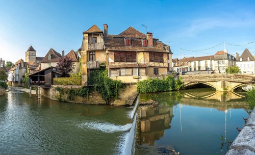 Picturesque view of the canal flowing through salies de bearn, a charming village located in the