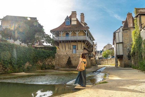 Tourist enjoying the picturesque architecture and the saleys river flowing through the charming