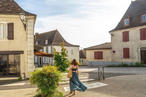 Tourist exploring charming streets of salies de bearn in france, enjoying summer vacation in a