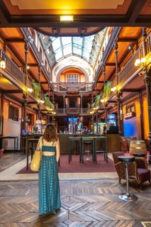 Tourist admiring the belle epoque architecture of the casino of salies de bearn, with its wooden