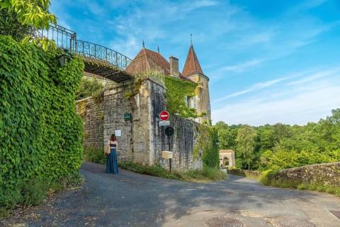 Tourist walking in the beautiful medieval village of sauveterre de bearn, in the pyrenees