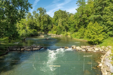 Whitewater course flowing through green lush vegetation in sauveterre de bearn, france, providing