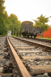 Railway tracks in the foreground leading to a historic train carriage, Nagold, district of Calw,