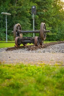 Two upturned train wheels on tracks against a green background. Atmosphere of peace and nature,
