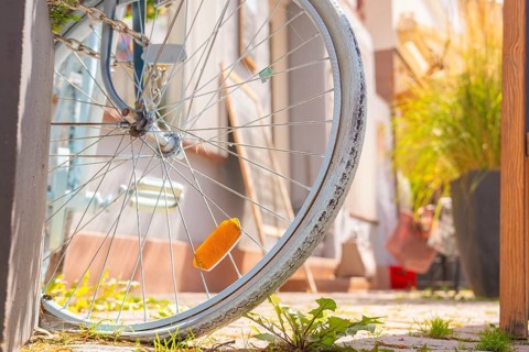 Close-up of a labelled bicycle tyre with green city pavement, small town of Perle Calw, district of