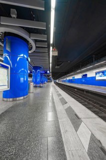 Modern underground station with blue design, empty platforms and smooth surfaces, Munich, Germany