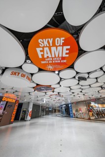 Modern shopping centre with eye-catching ceiling structure and various shops, Munich, Germany