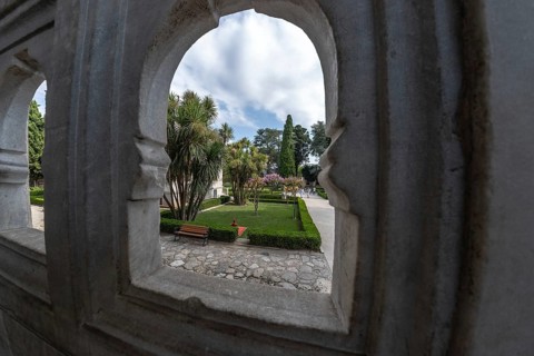 Lush gardens, framed by ornate stone arches, offer a tranquil escape in the heart of istanbul,