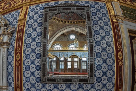 Luxurious mirror reflecting the ornate interior of a room in topkapi palace, showcasing ottoman