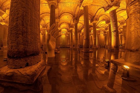 Giant hand sculpture rising from the water surface of the ancient basilica cistern in istanbul,