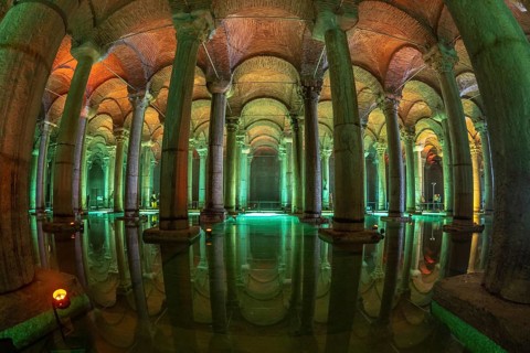 Ancient underground water reservoir with many columns reflecting on the water surface and