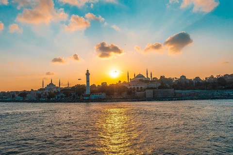 Golden sunset illuminating hagia sophia and ancient lighthouse in the bosphorus strait in istanbul,