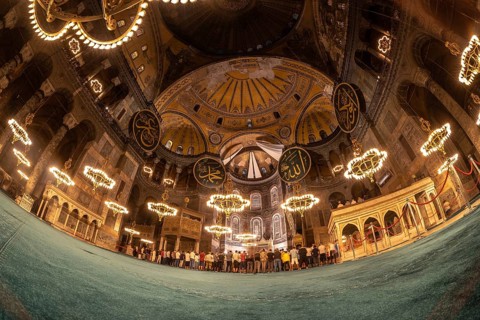 Fisheye view of muslim people praying inside the magnificent hagia sophia grand mosque in istanbul,