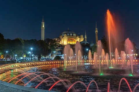 Colorful illuminated fountain jets dancing in front of the hagia sophia in istanbul, turkey,