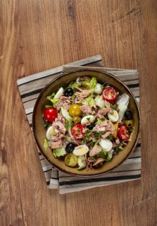Salad with canned tuna, vegetable salad with quail eggs, lettuce, red onion, cherry tomatoes,