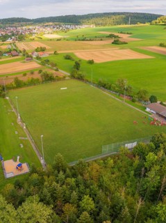 Sports field with neighbouring fields and trees near a village, VFL Stammheim, Calw, Black Forest,