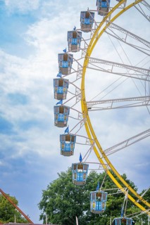 Detailed view of a giant Ferris wheel with blue cabins in front of a blue sky, Olympic Park,