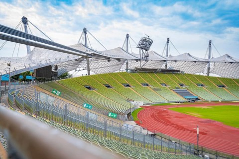 Exterior view of the stadium with striking tent structure and red running track, Olympic Park,