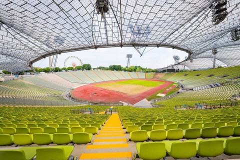 Panoramic view of a modern empty stadium with striking glass roof, Olympiapark, Munich, Germany