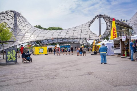 People enjoying a leisure event in a modern architectural setting, Olympiapark, Munich, Germany