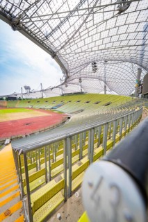 Close-up in the stadium with empty seats and striking roof construction, Olympiapark, Munich,