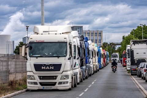 Truck tractors, exclusively from Eastern European countries, park in the harbour area, the canal