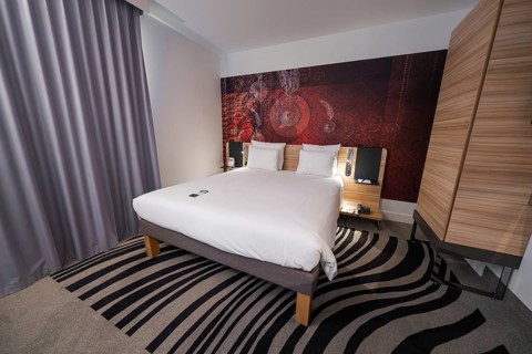 Cosy hotel room with modern design, elegant curtains and creative carpet pattern, Munich, Germany