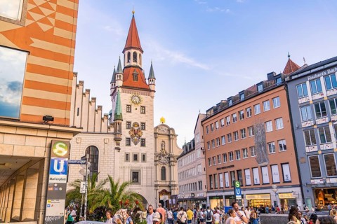Tower and busy street in Munich with people passing by in nice weather, Munich, Germany