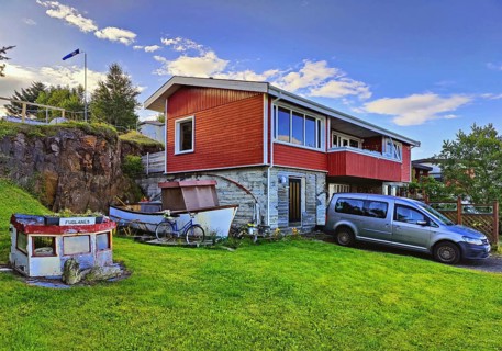 Front garden with old boats as decoration and mowed lawn, Vopnafjördur, East Iceland, Iceland