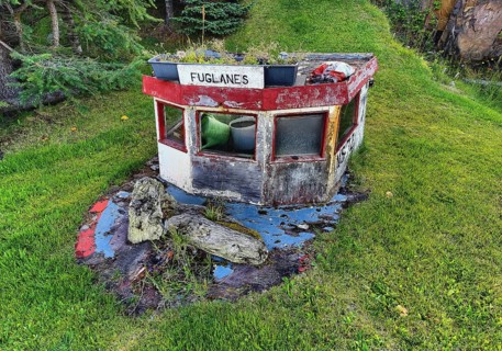 Front garden with old boat top as decoration and mown lawn, Vopnafjördur, East Iceland, Iceland