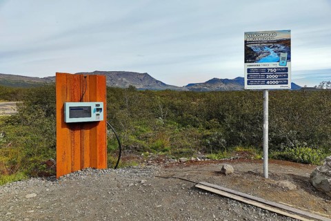 Car park at Brúarfoss waterfall with EC machines for paying in the countryside, South Iceland,