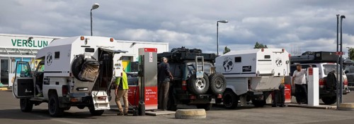 Several off-road vehicle drivers refuelling at self-service petrol stations, Reykjalith, Myvatn,