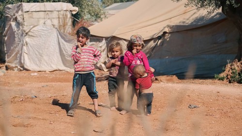 Syrian children playing in a refugee camp near the Turkish border on World Children's Day. Aleppo,