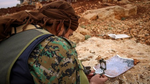 Syrian opposition fighters planning military strategies in preparation for clashes with ISIS.
